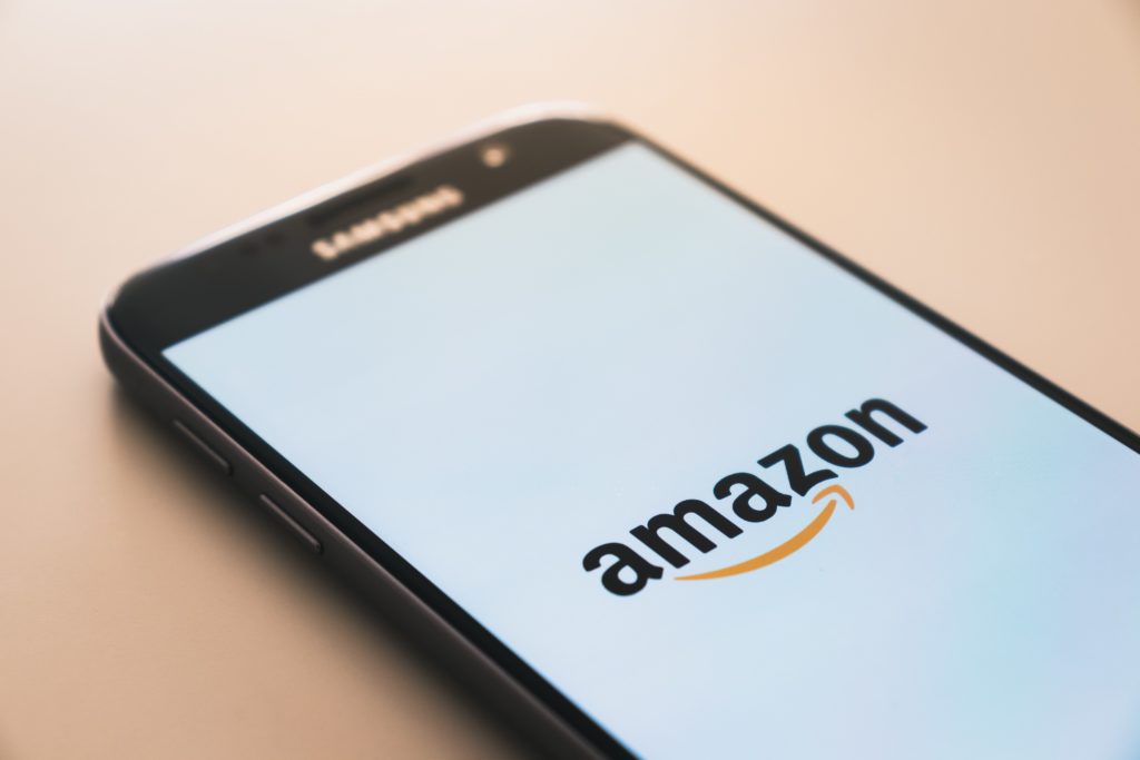 The brand and logos for Amazon, displayed on a smartphone screen.